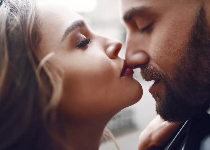 Момичето целува човека в носа