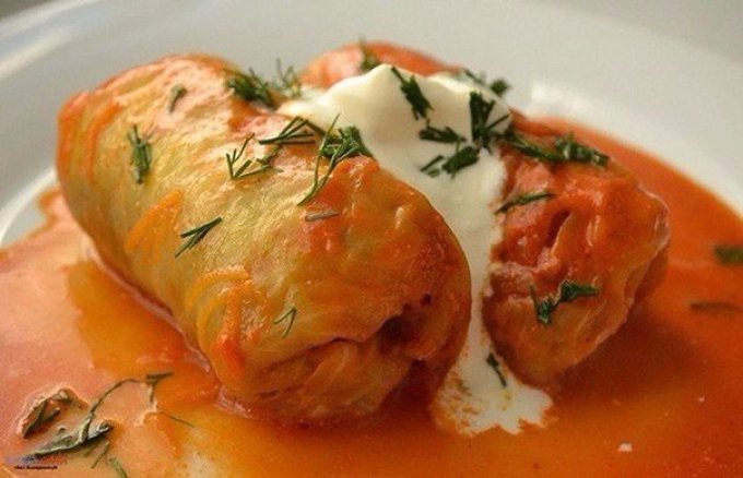 Cabbage rolls under a sauce of sour cream and tomato paste