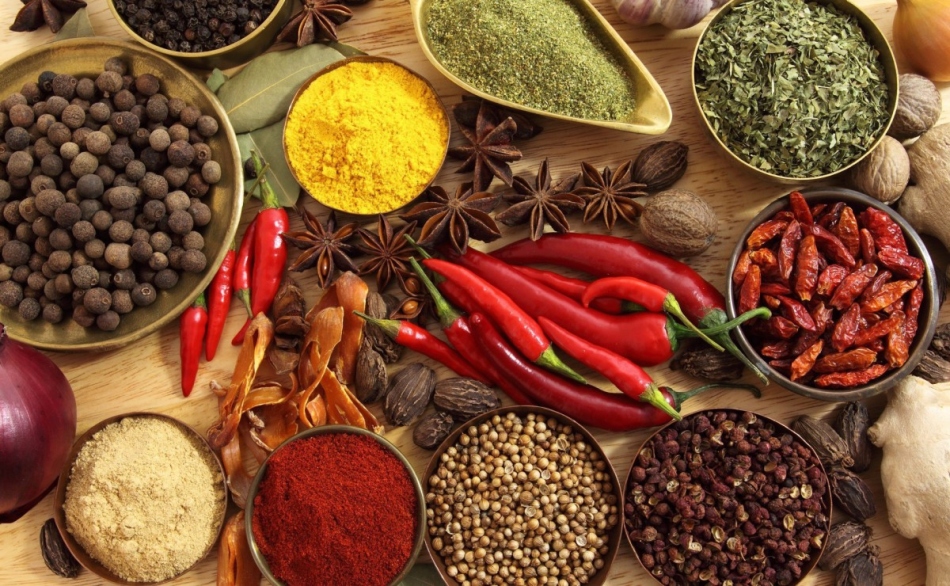A variety of seasonings and herbs on the table necessary for the preparation of acute seasonings from fruits and berries