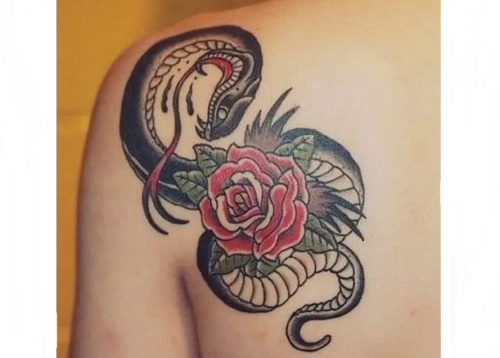Fashionable tattoo on a shoulder blade with a snake