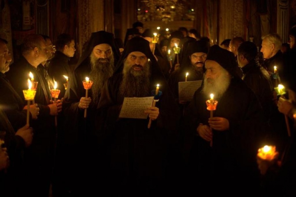 Jewish monks pray aloud in the temple with lighted candles