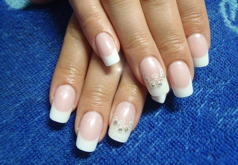 Manicure di nozze con strass e un motivo su un dito