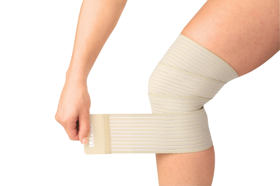 The girl imposes a tight supplement to limit the knee joint due to its pain and cryst