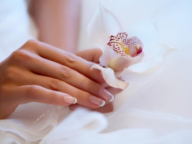 Fashionable wedding manicure: white nail design. Wedding nails - bride manicure