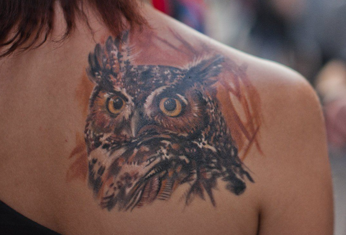 Beautiful tattoos with birds on a shoulder blade
