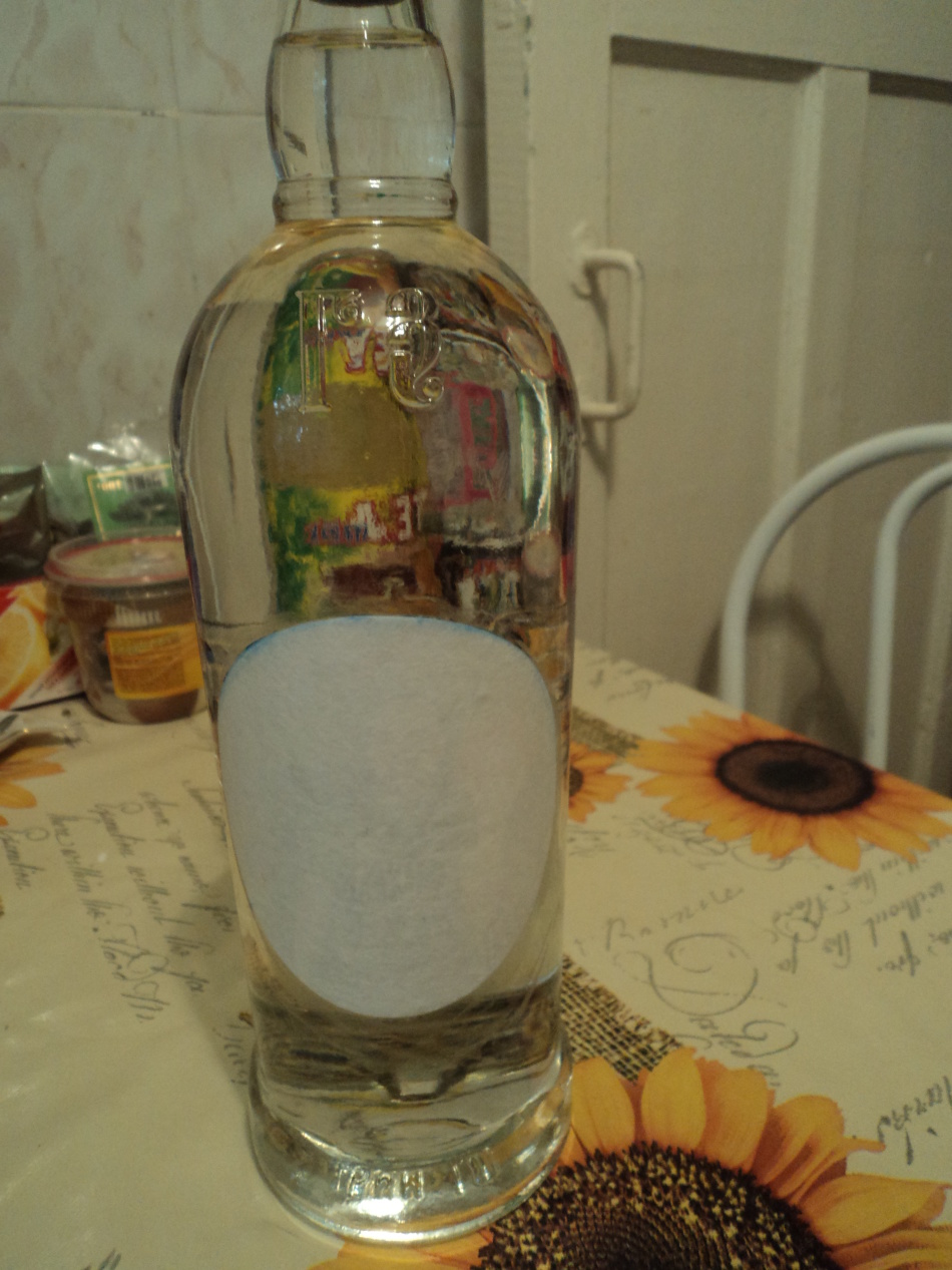Sticking a photo on a bottle during decoupage