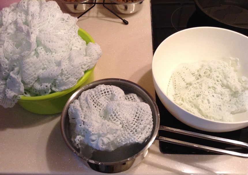 Crochet napkins in the process of starching with potato starch