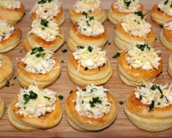 Quick snacks from puff pastry. Snakes for the New Year from puff pastry. A snack of puff pastry with crab sticks, with herring, chicken and champignons