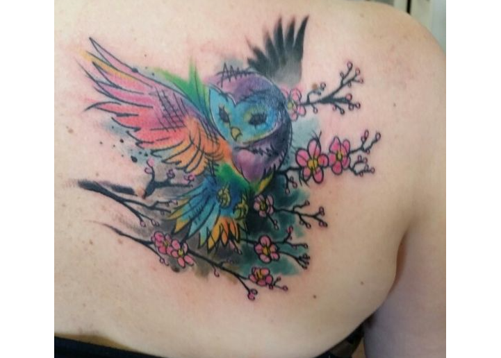 Beautiful tattoos with birds on a shoulder blade