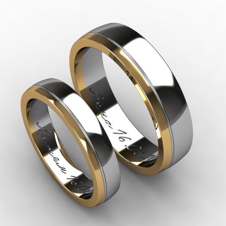 Koka ringar gjorda av vitt och gult guld med ett datum som är viktigt för älskare