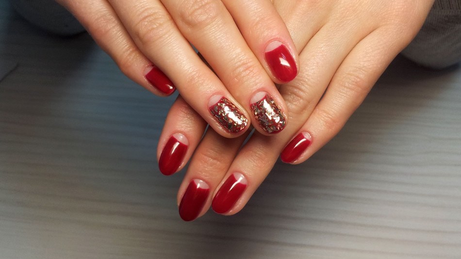 Red manicure with holes