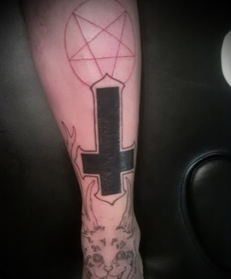 Tattoo with an inverted cross.