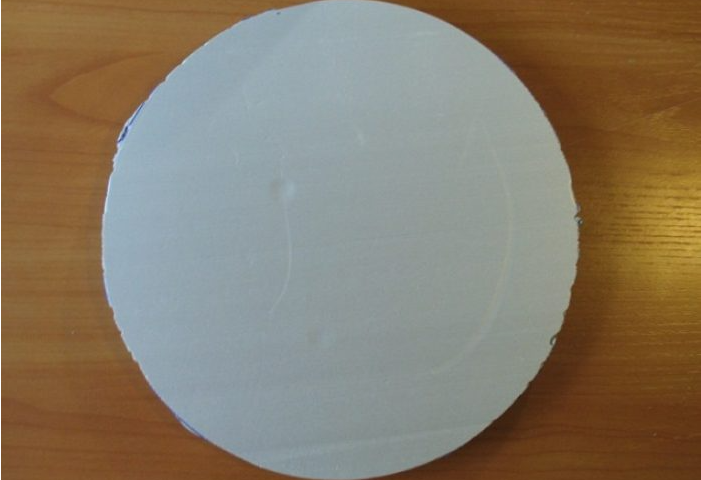Take a dense foam, draw and cut a disk out of it
