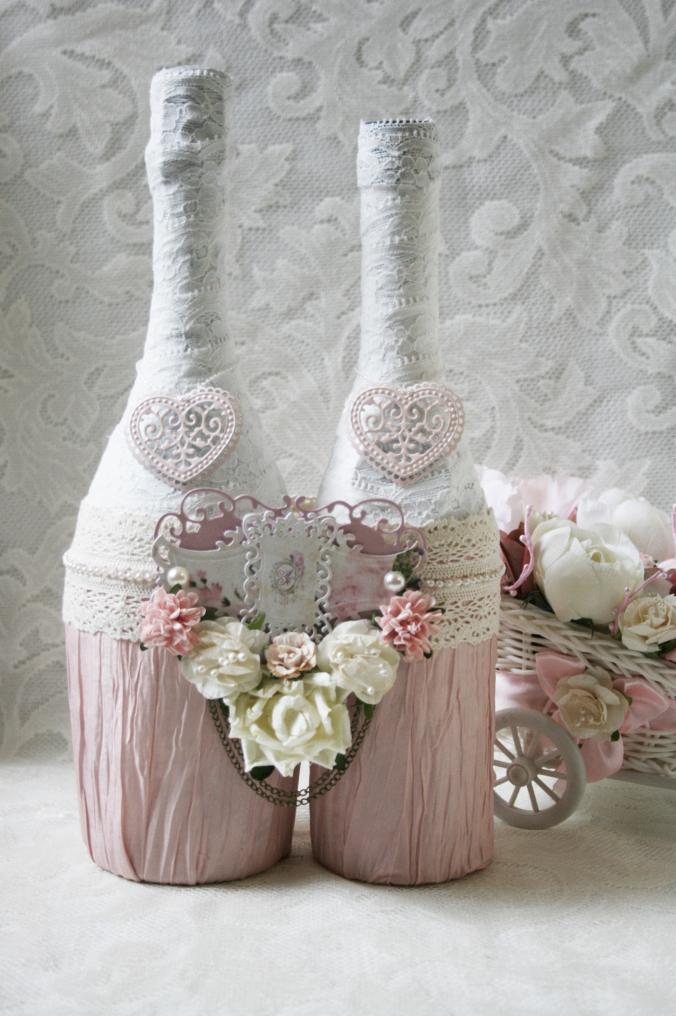The bottles decorated with decoupage are interconnected as a symbol of marriage strength