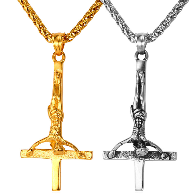 Крест святого петра из металла желтого и белого цветов.