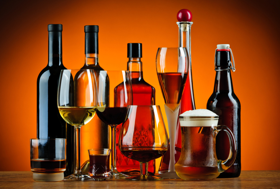 Botellas y vasos con diferentes tipos de bebidas alcohólicas