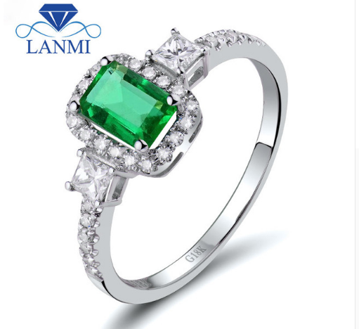 Golden ring made of white gold with emerald