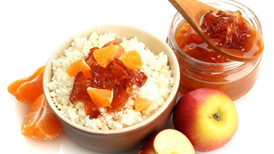 The photo has a delicious dessert - oranges and apples with cottage cheese!