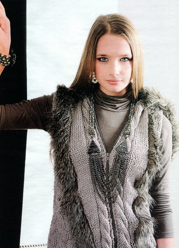 Stylish knitted vest with fur with fur on a girl