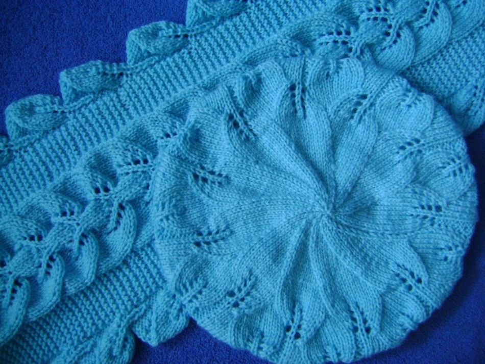The pale blue knitted with knitting needles takes with leaves and a scarf to it