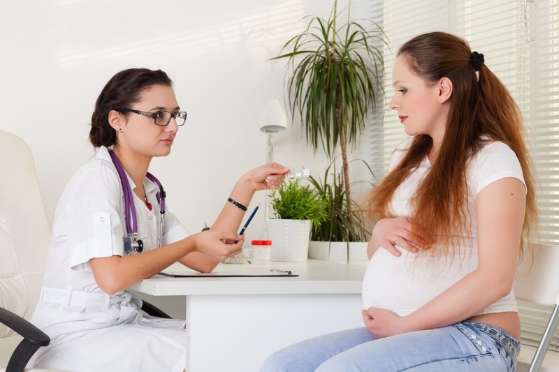Wanita hamil di janji dengan seorang ginekolog dalam konsultasi wanita