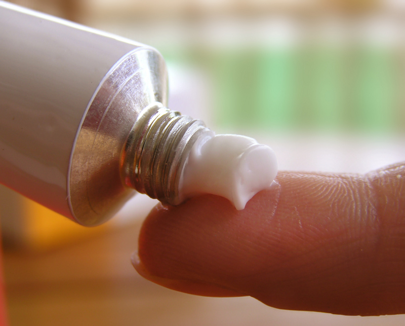 The ointment is squeezed out onto the finger to lubricate the sore knee