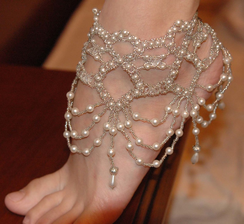 Bracelet from beads and pearls on the leg.