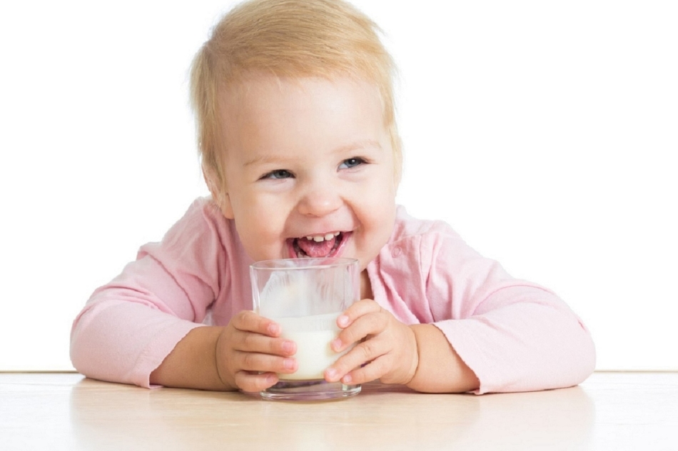 11 monthly baby drinks kefir from a glass