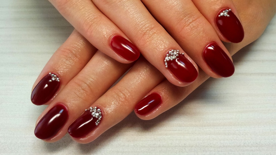 Red nail design with rhinestones