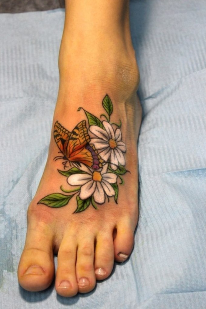 Lovely chamomile tattoos on the female foot