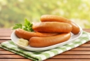 How many minutes to cook sausages are fresh and frozen, in a natural shell, after boiling?