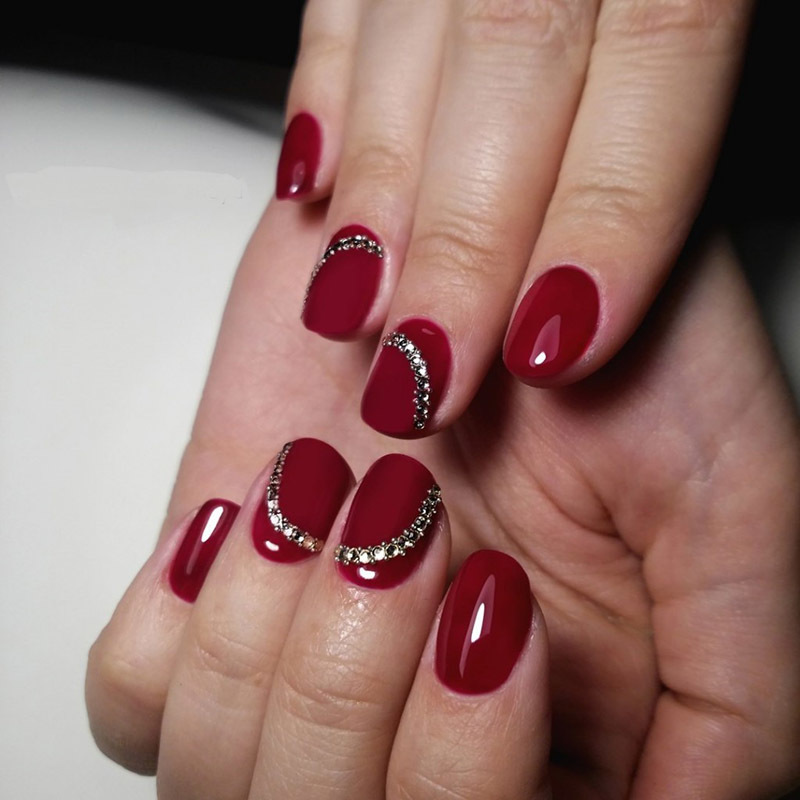 Red manicure with stones