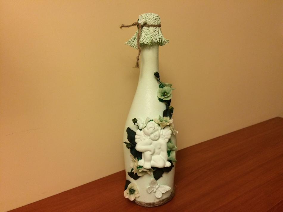 Decoupage bottles with flowers and an angel figure