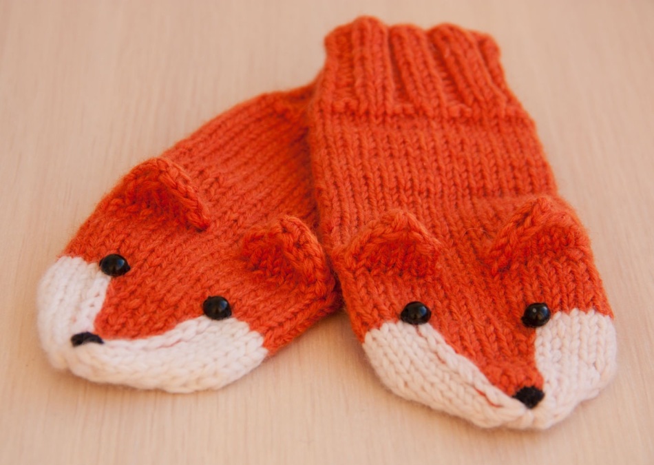 Cute mittens of lysichca for a child associated with knitting needles