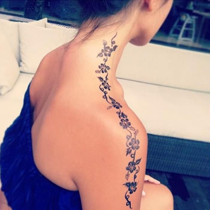 Another longitudinal tattoo from neck to shoulder