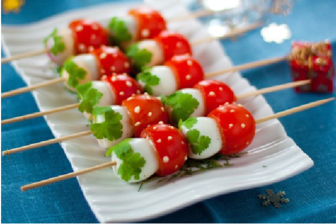 Option for feeding snacks from quail eggs with cherry tomatoes on skewers