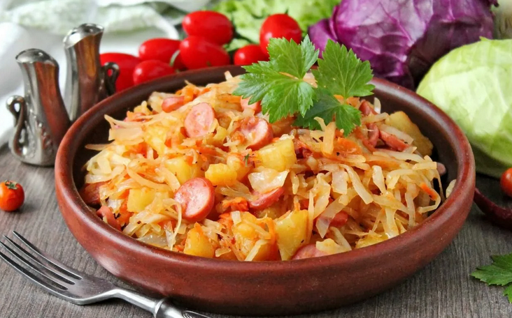 Stewed fresh cabbage with sausages