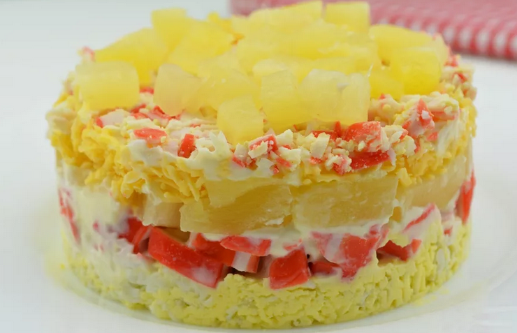 Delicious crab salad with pineapples, eggs and hard cheese
