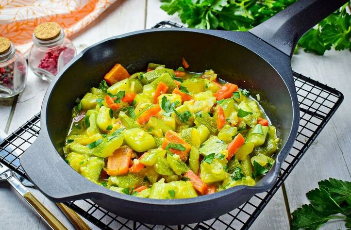 Stewed zucchini with carrots and onions