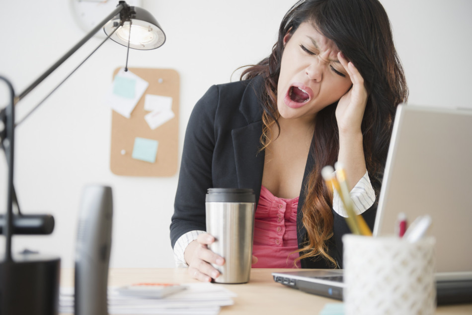 Woman yawns at work
