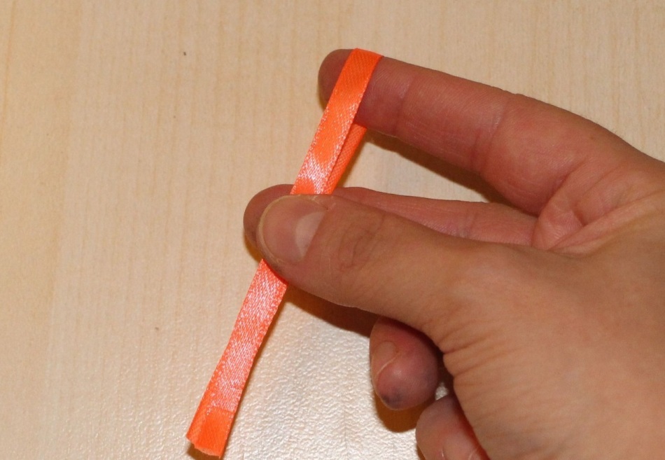 When folding a tape for a girlfriend of a ball, it is worth holding her with a finger