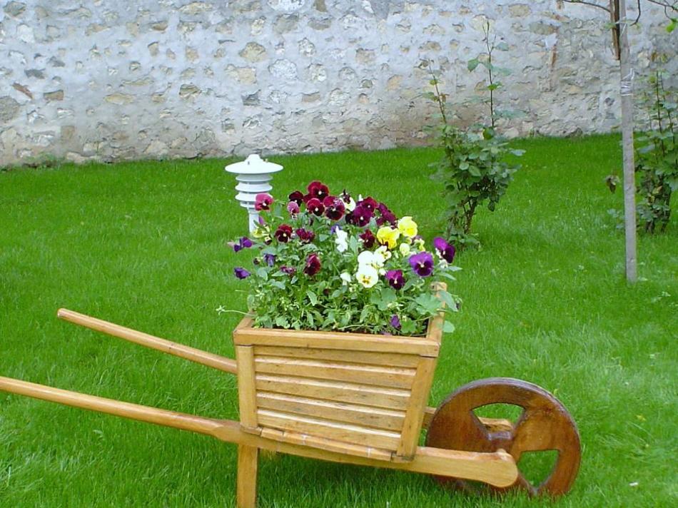 A wooden box installed on part of the old cart is an unusual and spectacular pot