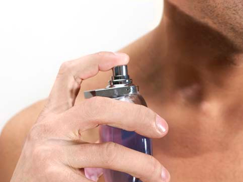 Un homme utilise de l'eau de toilette