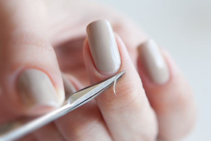 Removing the cuticle with scissors.