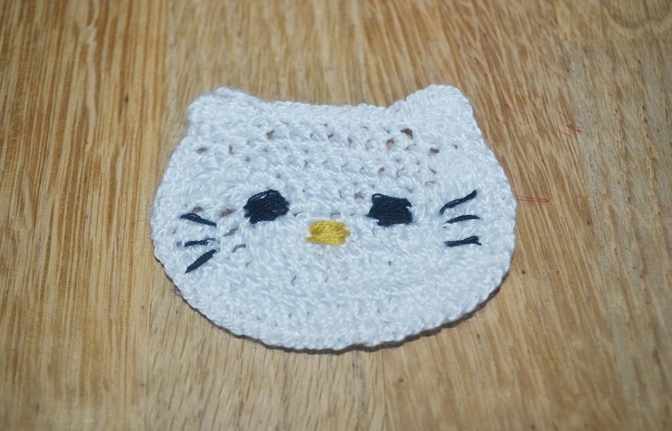 Embroidery of the muzzle of the cat-laying