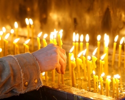 What does a big, common candle in the church mean