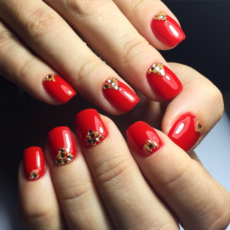 Red manicure with stones