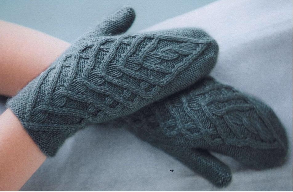 Cute mittens with knitting needles with arana on the hands of the model