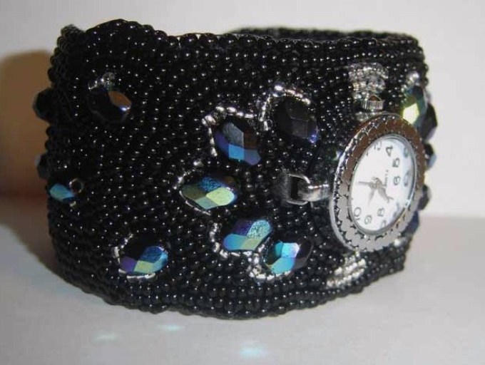 Watch with a wide bead strap.