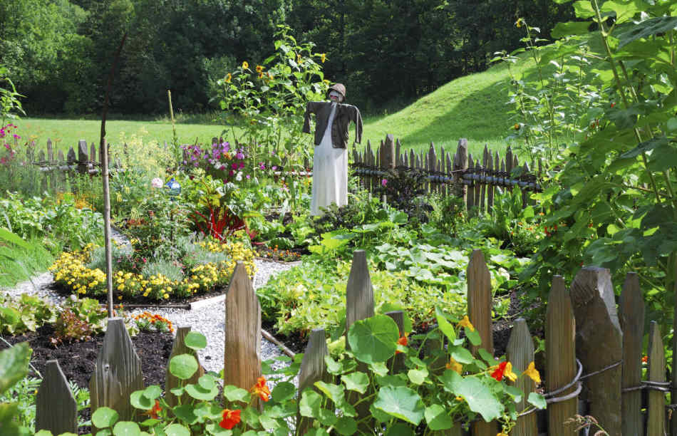 Garden scarecrow as an element of a private yard decor